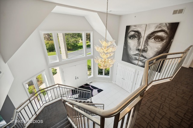 stairs with an inviting chandelier