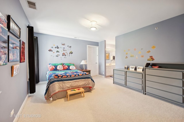 carpeted bedroom featuring ensuite bath