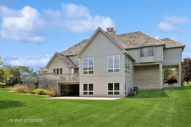 rear view of property featuring a yard, a patio area, central AC, and a deck