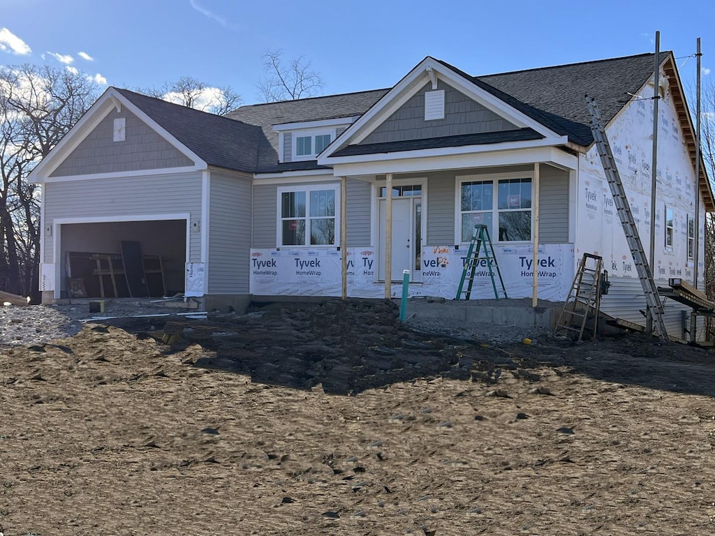 view of front facade with a porch and a garage