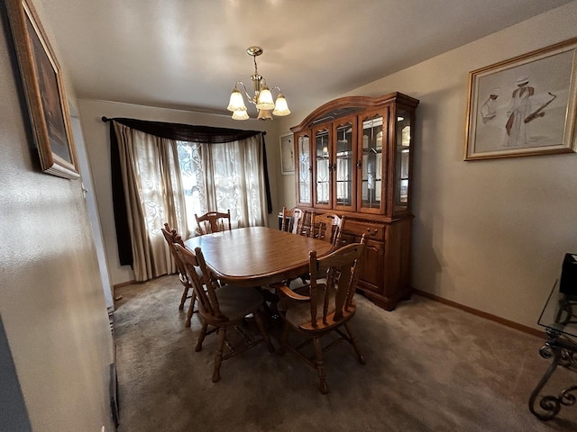 dining area with carpet, baseboards, and a notable chandelier