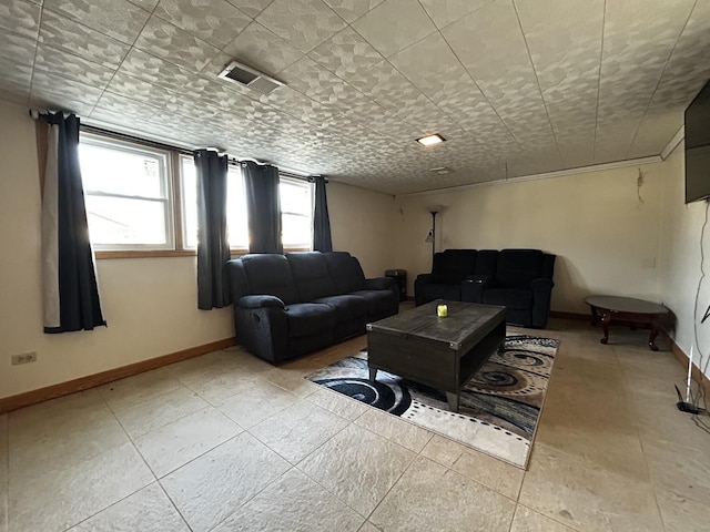 living room with baseboards and visible vents