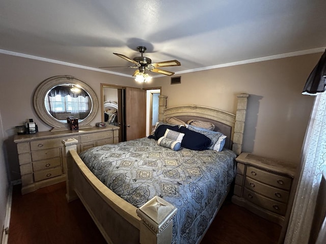 bedroom featuring ceiling fan, visible vents, a closet, dark wood finished floors, and crown molding