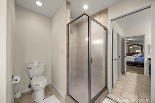 full bath with tile patterned flooring, toilet, a stall shower, and ensuite bath