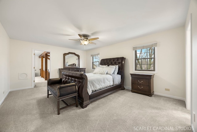 bedroom with a ceiling fan, light colored carpet, and baseboards