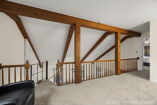 interior space with lofted ceiling with beams and carpet
