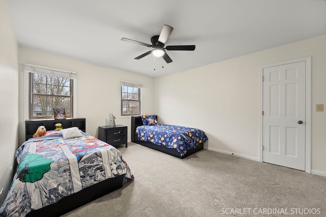 carpeted bedroom with a ceiling fan and baseboards