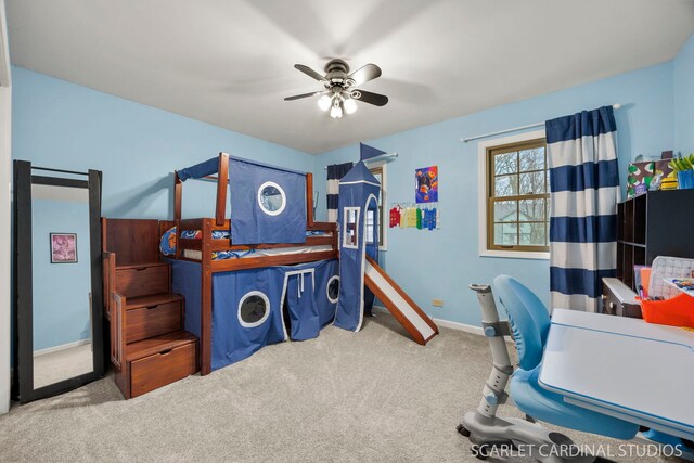 carpeted bedroom with a ceiling fan and baseboards