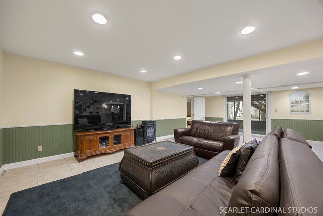 living room with tile patterned flooring, recessed lighting, and a wainscoted wall