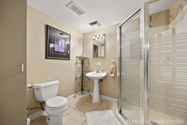 full bath featuring tile patterned floors, toilet, visible vents, and a shower stall