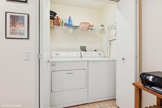 laundry area featuring light tile patterned floors and washing machine and clothes dryer