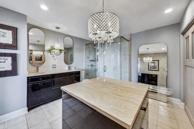 kitchen with a notable chandelier, decorative light fixtures, and sink