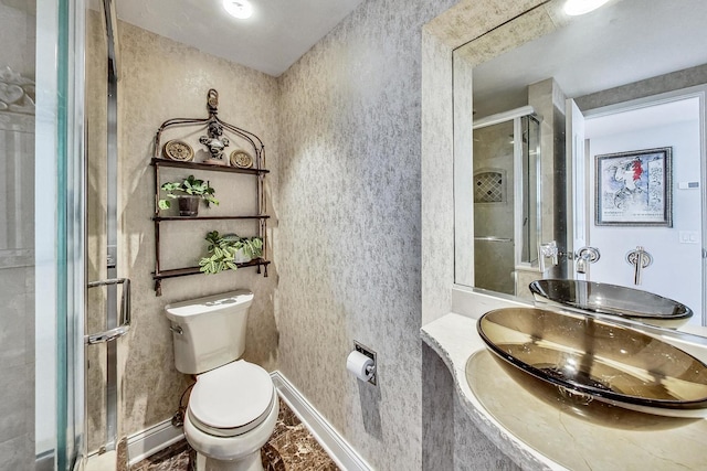 bathroom with vanity, a shower with shower door, and toilet