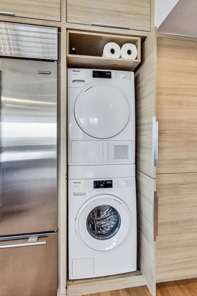 clothes washing area featuring stacked washer / drying machine