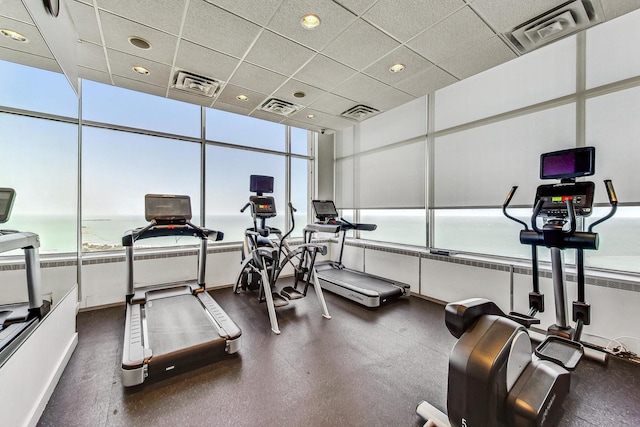 gym with a wealth of natural light and a paneled ceiling