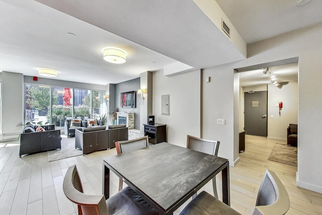 dining area with baseboard heating and light hardwood / wood-style flooring