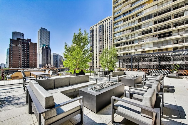 view of patio / terrace featuring an outdoor living space with a fire pit