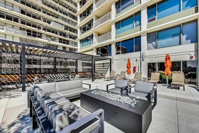 view of patio featuring an outdoor living space with a fire pit