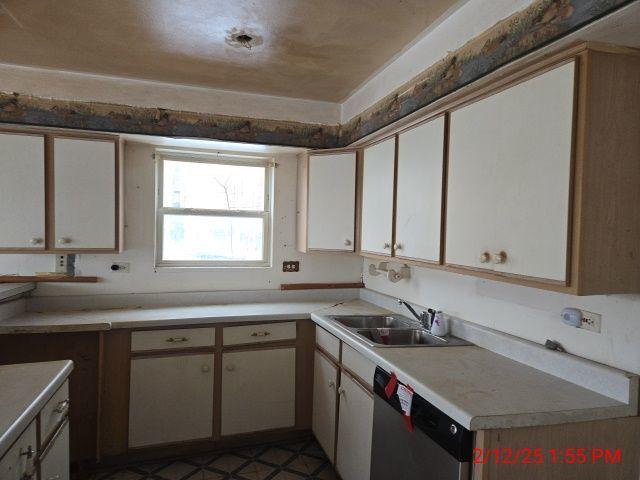 1838 S Springfield Ave Unit A, Chicago, IL 60623 - kitchen with dishwasher, sink, and white cabinets