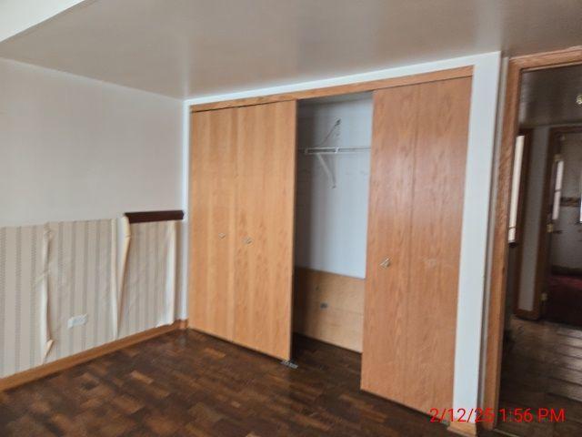 1838 S Springfield Ave Unit A, Chicago, IL 60623 - unfurnished bedroom with dark wood-type flooring and a closet