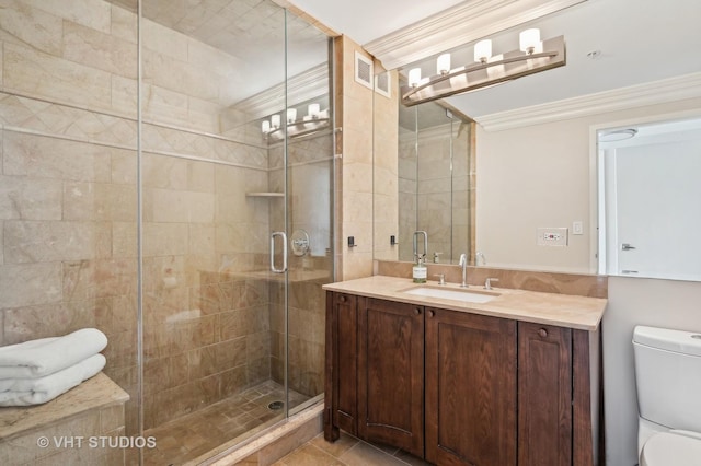 full bathroom with a stall shower, toilet, crown molding, and vanity