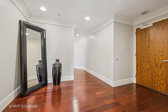 empty room with recessed lighting, ornamental molding, baseboards, and wood finished floors