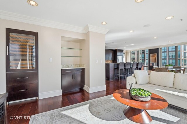 living room with recessed lighting, baseboards, dark wood finished floors, and ornamental molding