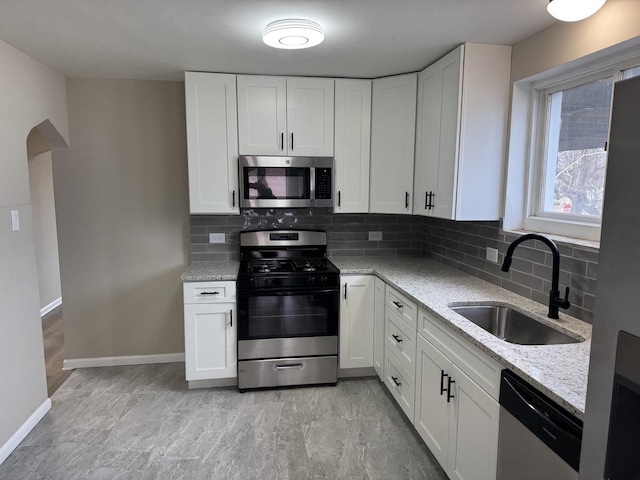 kitchen with white cabinetry, sink, and stainless steel appliances