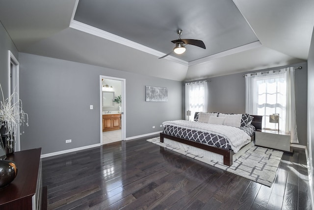 bedroom with ceiling fan, ensuite bath, dark hardwood / wood-style floors, and a raised ceiling