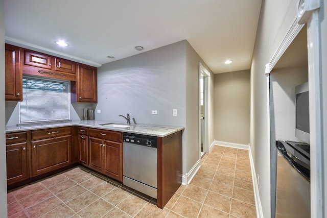 kitchen with dishwasher, light stone countertops, sink, and light tile patterned floors