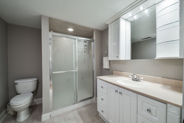 bathroom featuring vanity, tile patterned flooring, a shower with door, and toilet