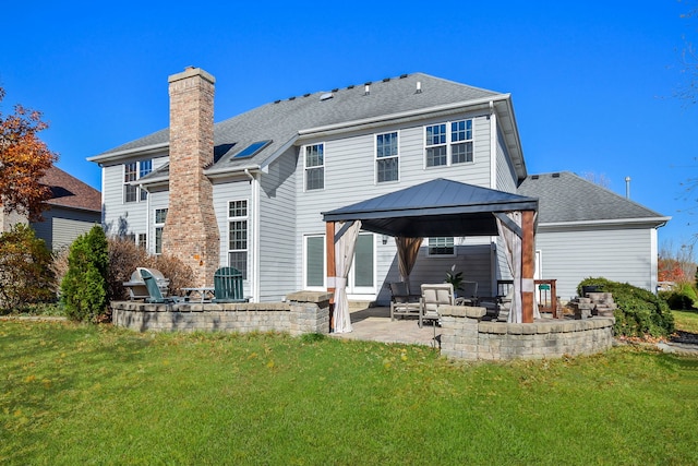 rear view of house with a gazebo, a patio, and a lawn