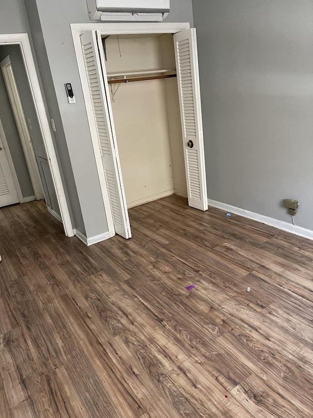 unfurnished bedroom featuring dark hardwood / wood-style floors and a closet