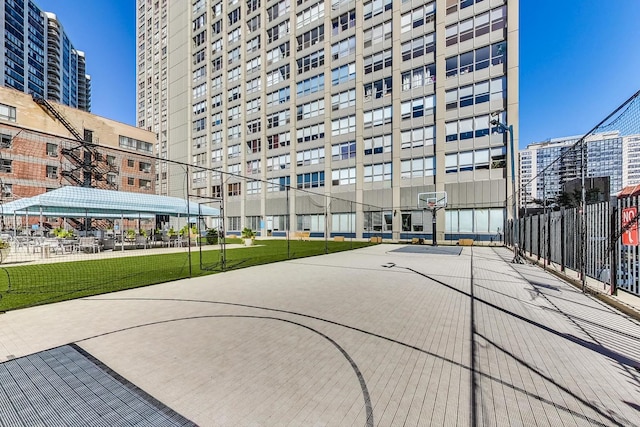 view of home's community with a lawn and basketball hoop