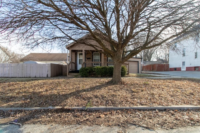 view of front of property featuring a garage and a porch