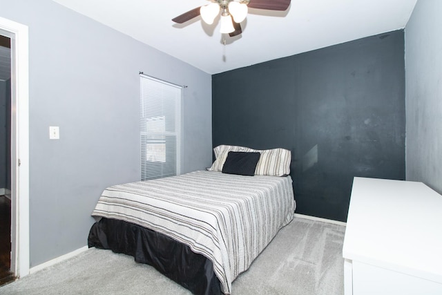 bedroom featuring light colored carpet and ceiling fan