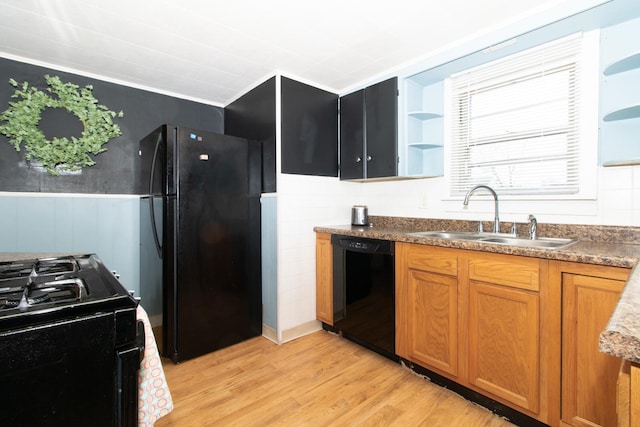 kitchen with crown molding, sink, light hardwood / wood-style flooring, and black appliances