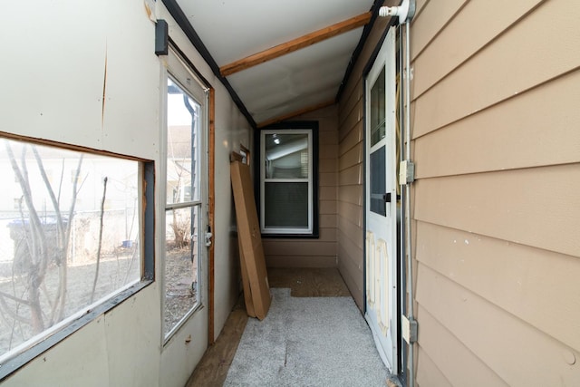 hallway with lofted ceiling