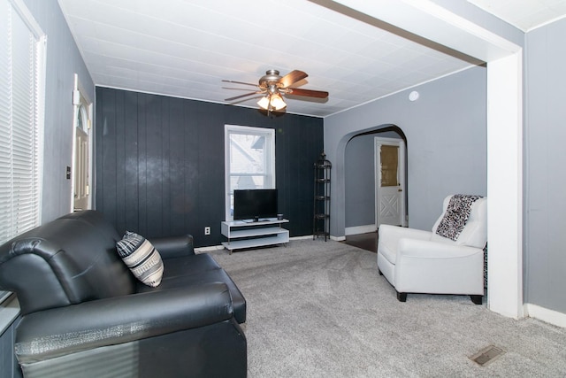 living room featuring ceiling fan and carpet