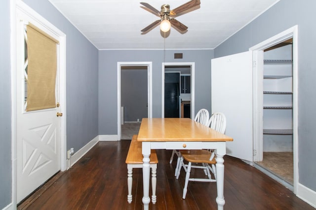 dining space featuring dark wood-type flooring and ceiling fan