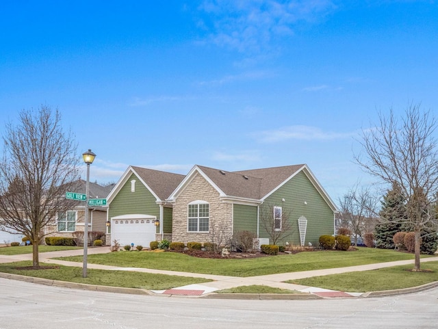 ranch-style home with a garage and a front lawn