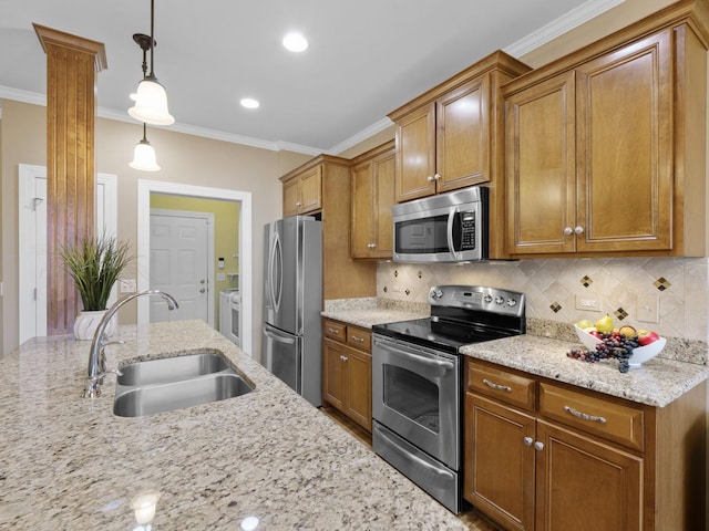 kitchen with sink, appliances with stainless steel finishes, backsplash, hanging light fixtures, and light stone counters