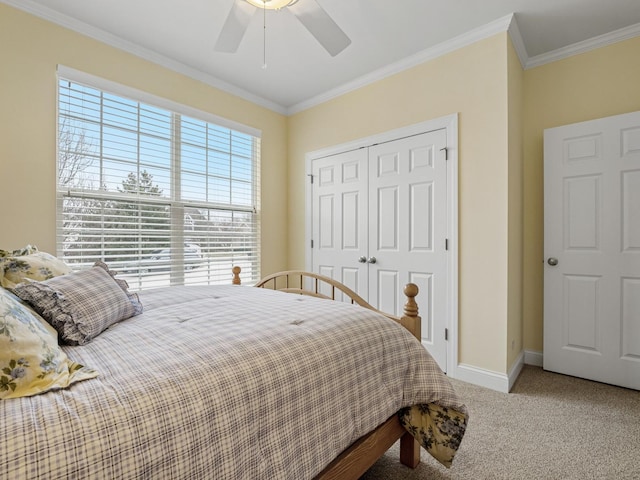 bedroom featuring carpet floors, ornamental molding, a closet, and ceiling fan