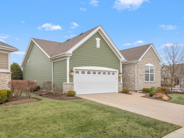 view of front of house with a garage and a front lawn