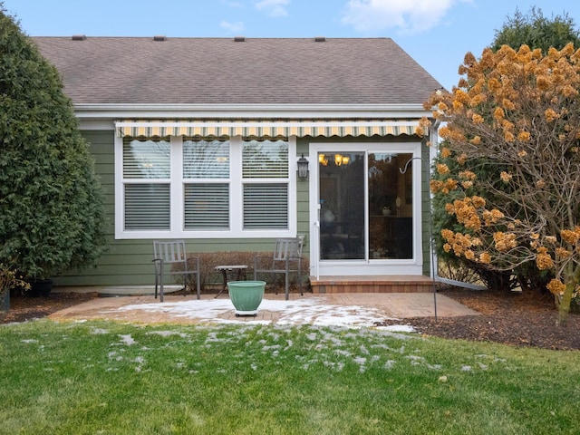 rear view of property with a patio and a lawn