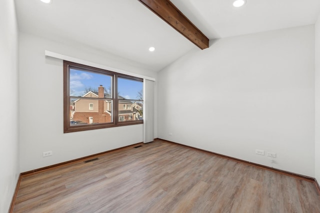 unfurnished room featuring lofted ceiling with beams and light hardwood / wood-style floors