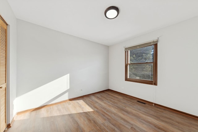 empty room with light hardwood / wood-style flooring