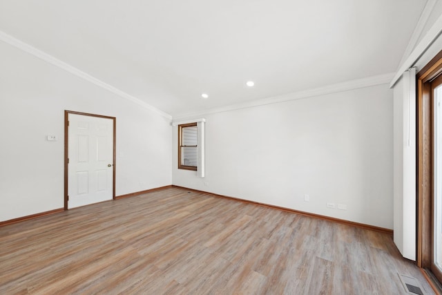 unfurnished room with ornamental molding, lofted ceiling, and light hardwood / wood-style flooring