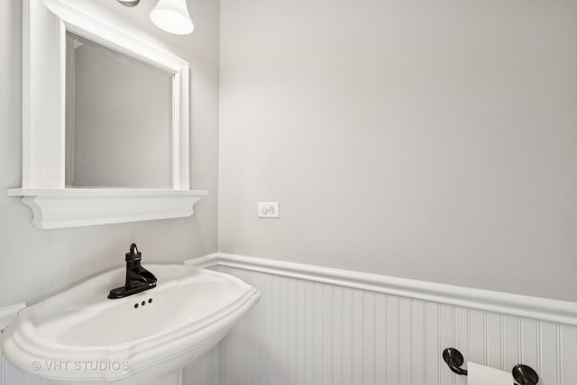 bathroom featuring wainscoting and a sink