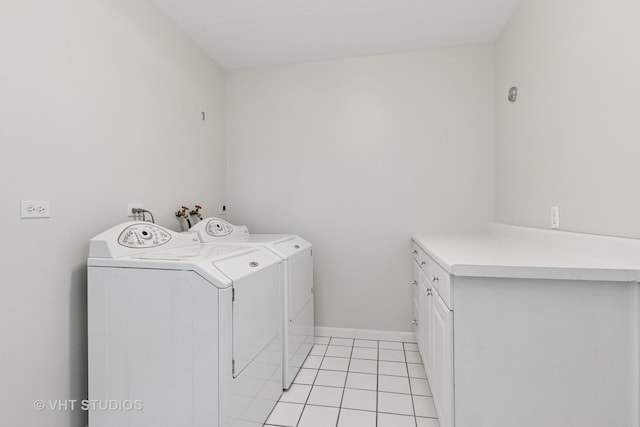 washroom with light tile patterned floors, baseboards, cabinet space, and independent washer and dryer